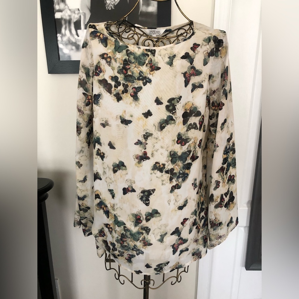 Long sleeve blouse with butterfly design and flare sleeves.